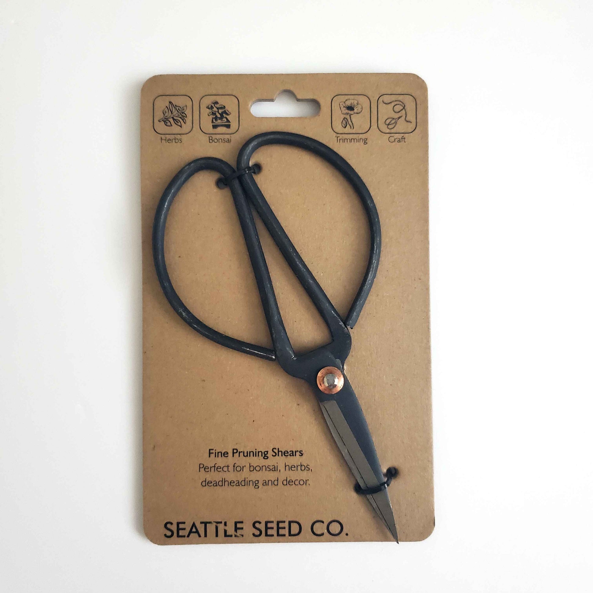 Black pruning shears on a brown cardboard packaging with 'Seattle Seed Co.' branding.