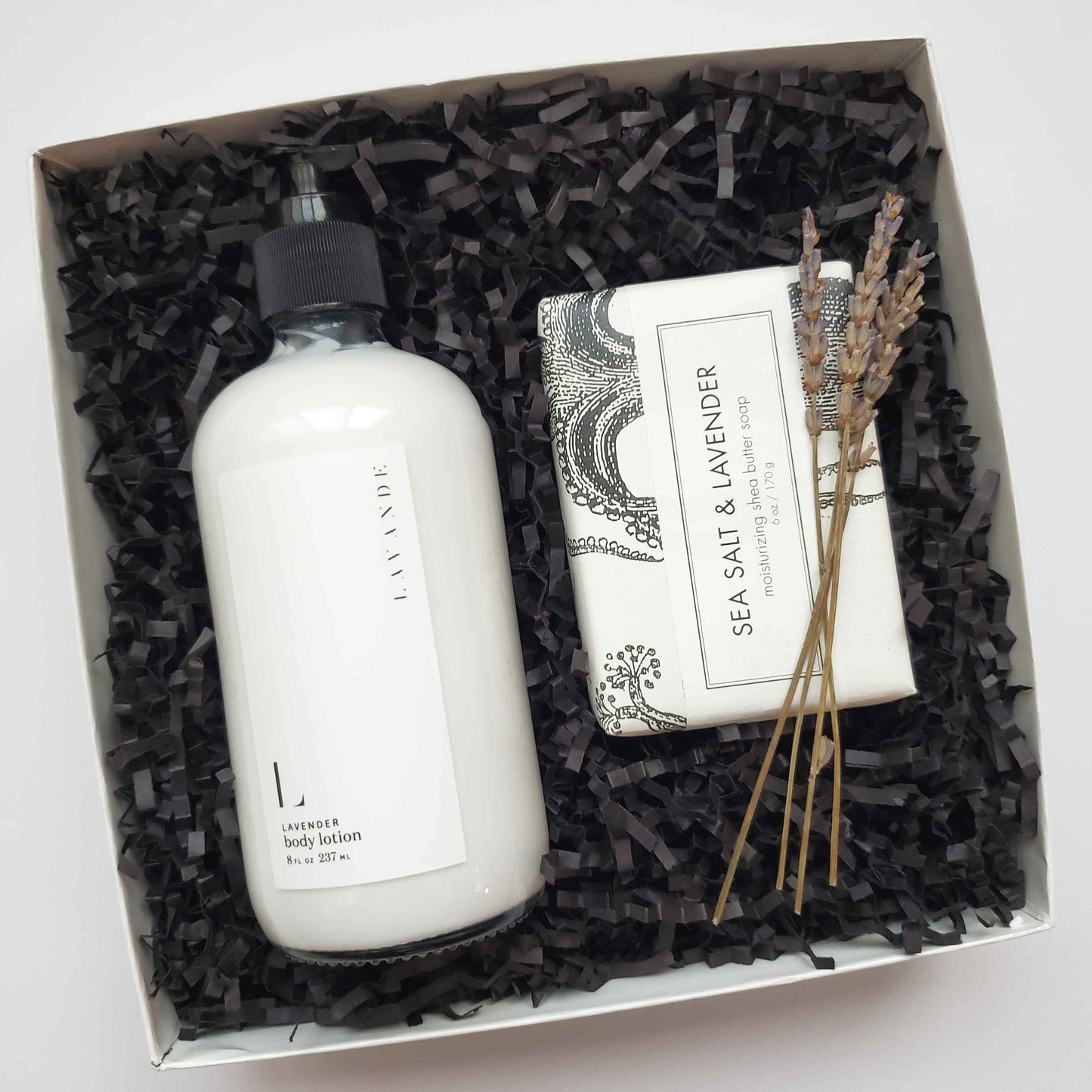Gift set with lavender body lotion, soap, and lavender sprigs in a gift box