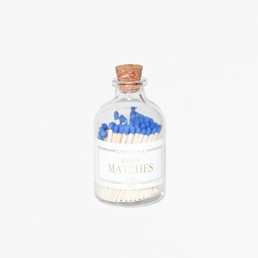 Blue tip matches in a apothecary glass bottle