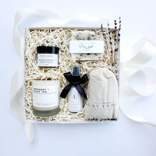 Load image into Gallery viewer, A self-care lavender gift box by The Gift Veil with a neutral color palette. Includes lavender soap, lotion, aromatherapy bath salts, a lavender sachet and a bergamot and black tea soy candle.
