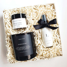 Load image into Gallery viewer, A black and white self care gift box from The Gift Veil which includes a candle, aromatherapy bath salts and lavender scented lotion.
