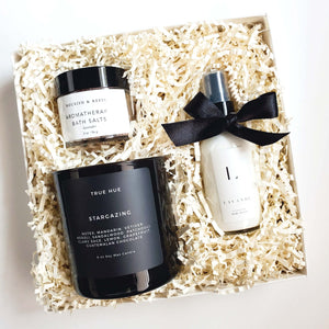 A black and white self care gift box from The Gift Veil which includes a candle, aromatherapy bath salts and lavender scented lotion.